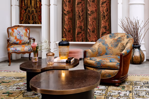 Elegant showroom with armchairs upholstered in Prelle silks and matching curtains
